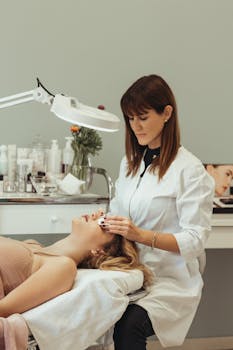 pexels-photo-16120490-16120490 A cosmetologist performing skincare procedures on a client in a salon setting.