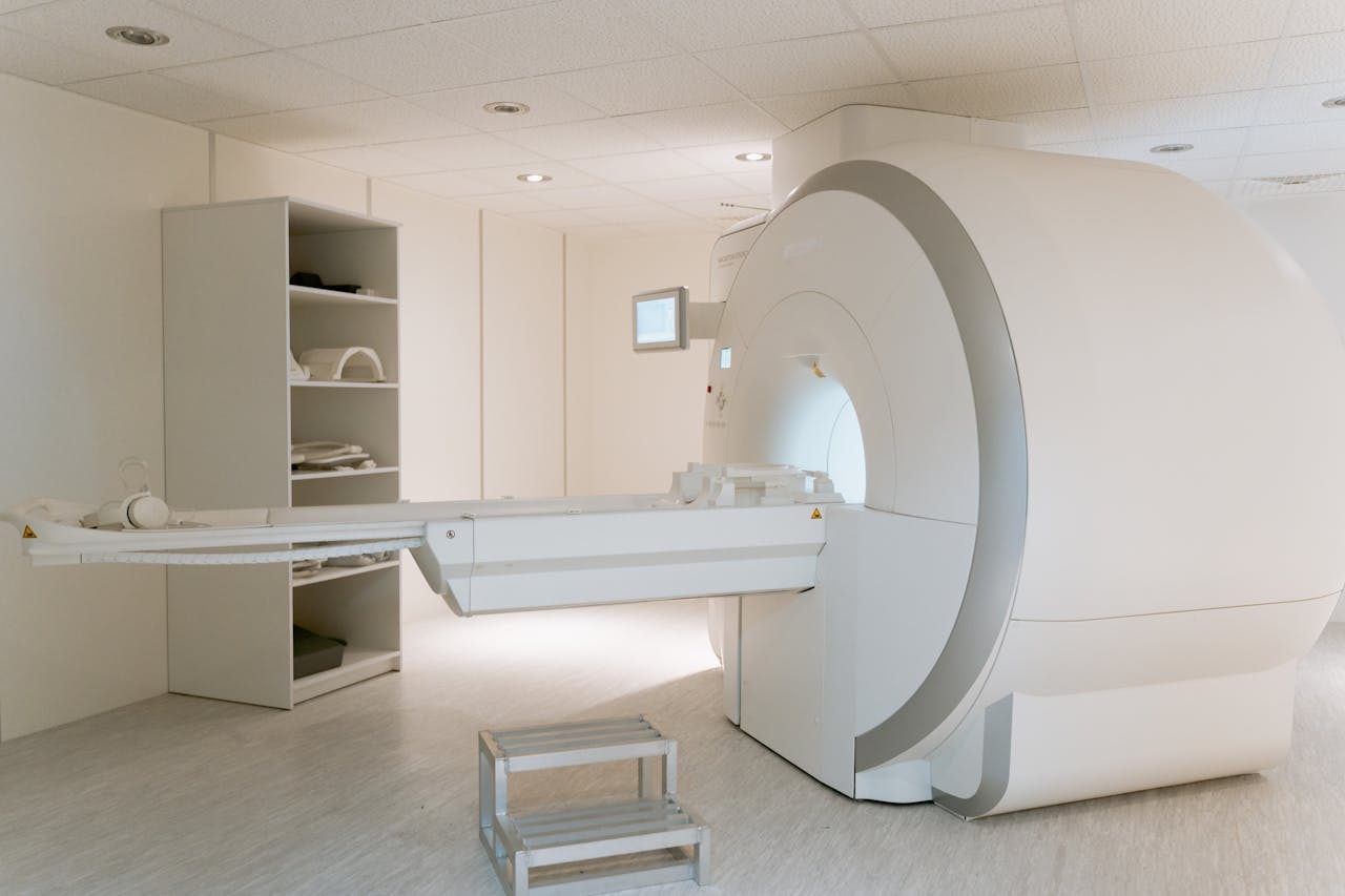 portfolio-06 Interior view of a modern MRI scanner room, showcasing advanced medical imaging equipment.